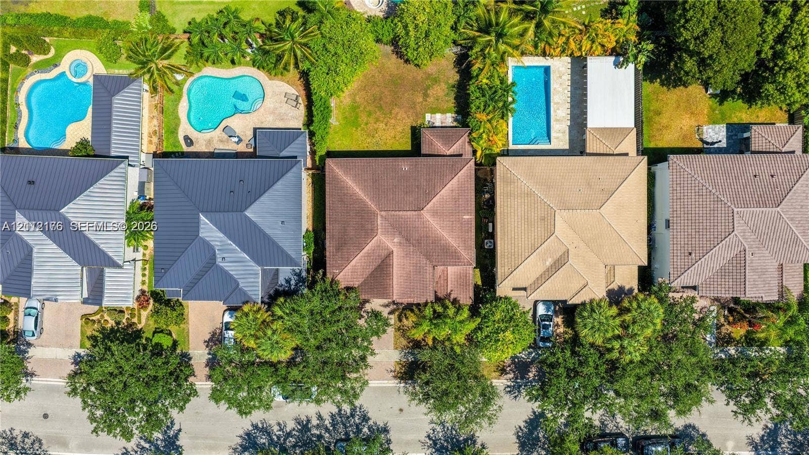 19143 Crystal Street, Weston, FL 33332 Aerial perspective of residential properties featuring hip-style roofing, paved driveways, and mature landscaping