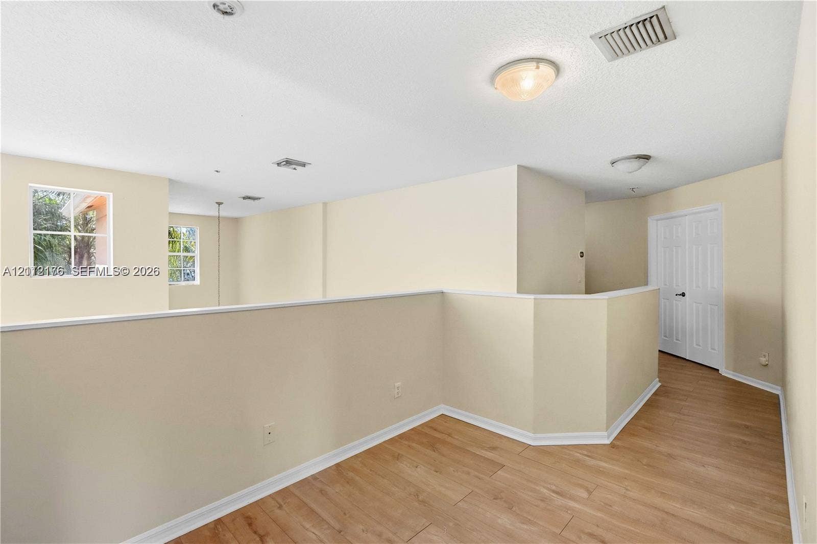 19143 Crystal Street, Weston, FL 33332 Open-concept mezzanine area featuring wood-finish flooring, recessed lighting, and white paneled doors