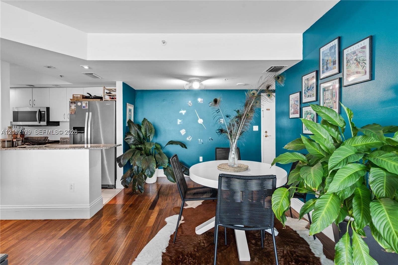 800 Claughton Island Drive, #1604, Miami, Miami, FL 33131 Open-concept kitchen featuring stainless steel appliances and a peninsula counter, set against wood-finish flooring