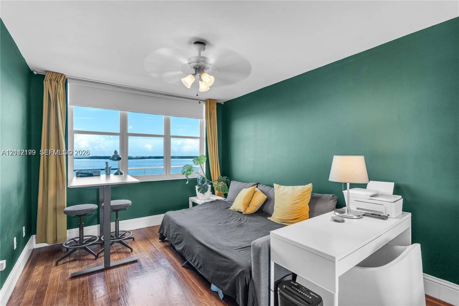 800 Claughton Island Drive, #1604, Miami, Miami, FL 33131 Wood-finish flooring, water-facing windows with roller shades, and a ceiling-mounted light fixture with fan