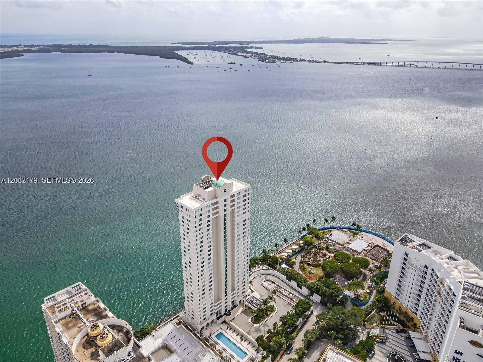 800 Claughton Island Drive, #1604, Miami, Miami, FL 33131 High-rise residential tower featuring a waterfront location, a rectangular swimming pool, and proximity to a causeway