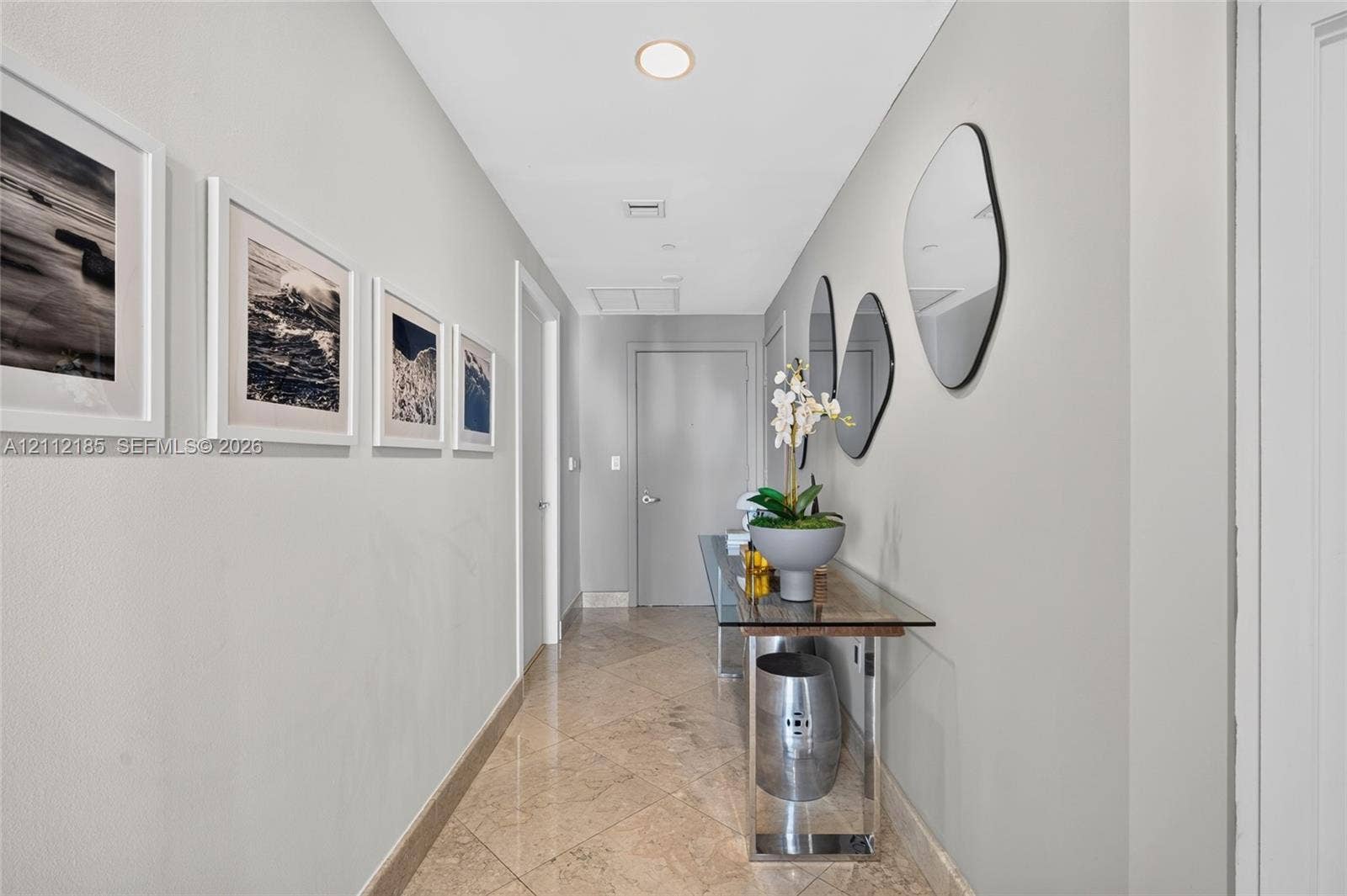 1060 Brickell Avenue, #2401, Miami, FL 33131 Hallway featuring polished stone-finish tile flooring, recessed ceiling lighting, and solid-core interior doors