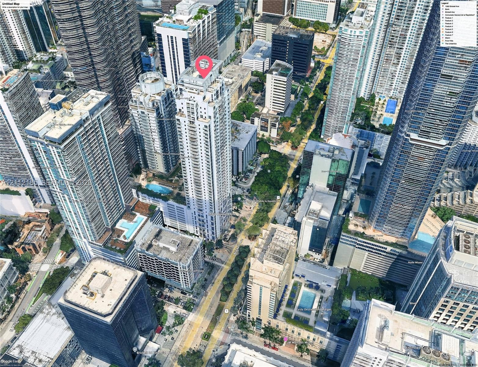 1060 Brickell Avenue, #2401, Miami, FL 33131 Aerial perspective of a high-rise condominium tower featuring a glass facade, multiple terraces, and a structured podium base situated within a dense urban center