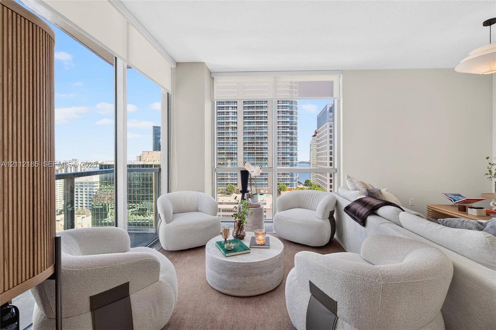 1060 Brickell Avenue, #2401, Miami, FL 33131 Floor-to-ceiling windows, motorized solar shades, recessed lighting, and a pendant light fixture