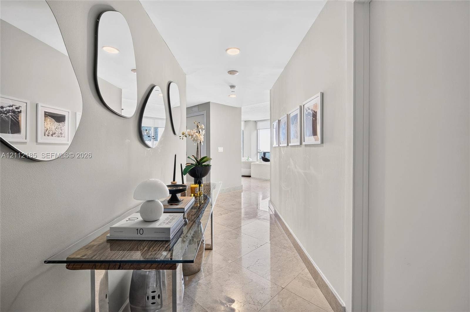 1060 Brickell Avenue, #2401, Miami, FL 33131 Interior hallway featuring polished stone flooring, recessed ceiling lighting, and neutral-toned wall paint