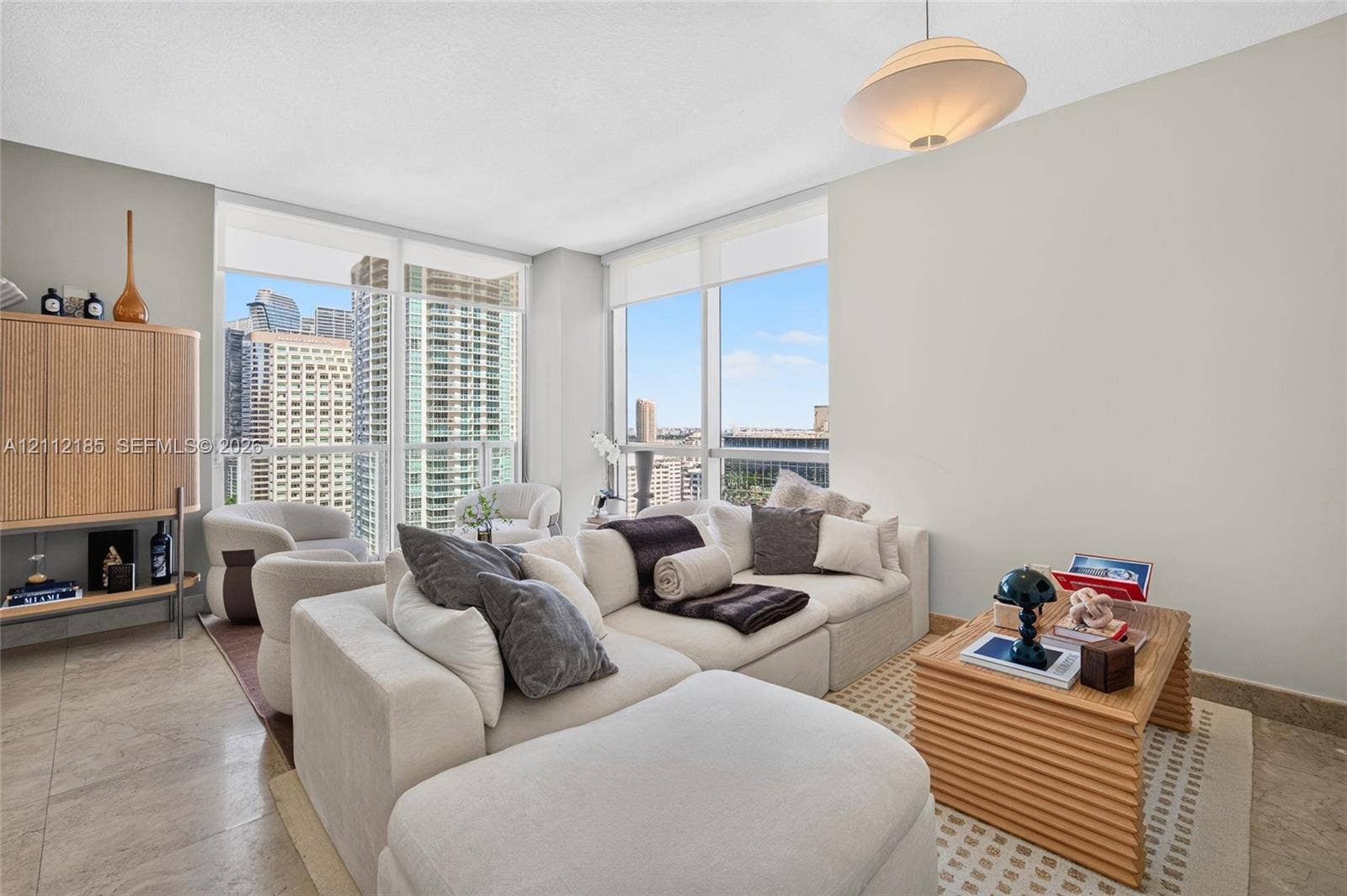 1060 Brickell Avenue, #2401, Miami, FL 33131 Floor-to-ceiling windows, stone-finish flooring, and recessed lighting fixture