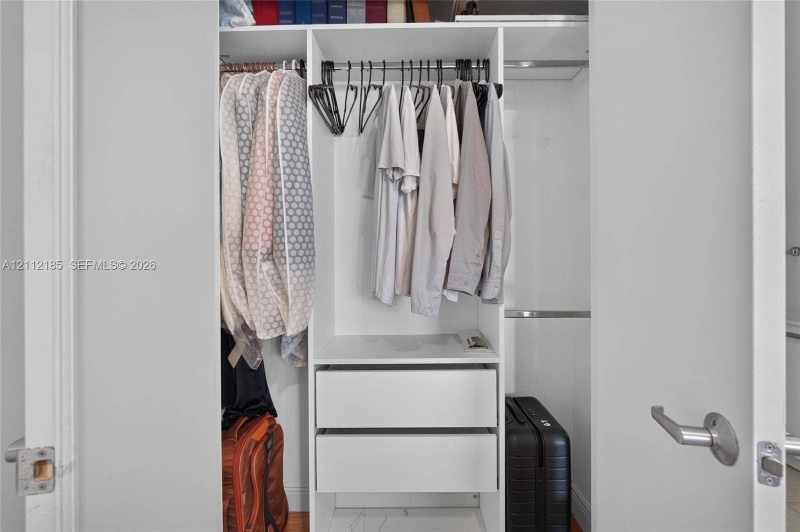1060 Brickell Avenue, #2401, Miami, FL 33131 Built-in closet featuring white cabinetry, dual integrated drawers, and metal hanging rods