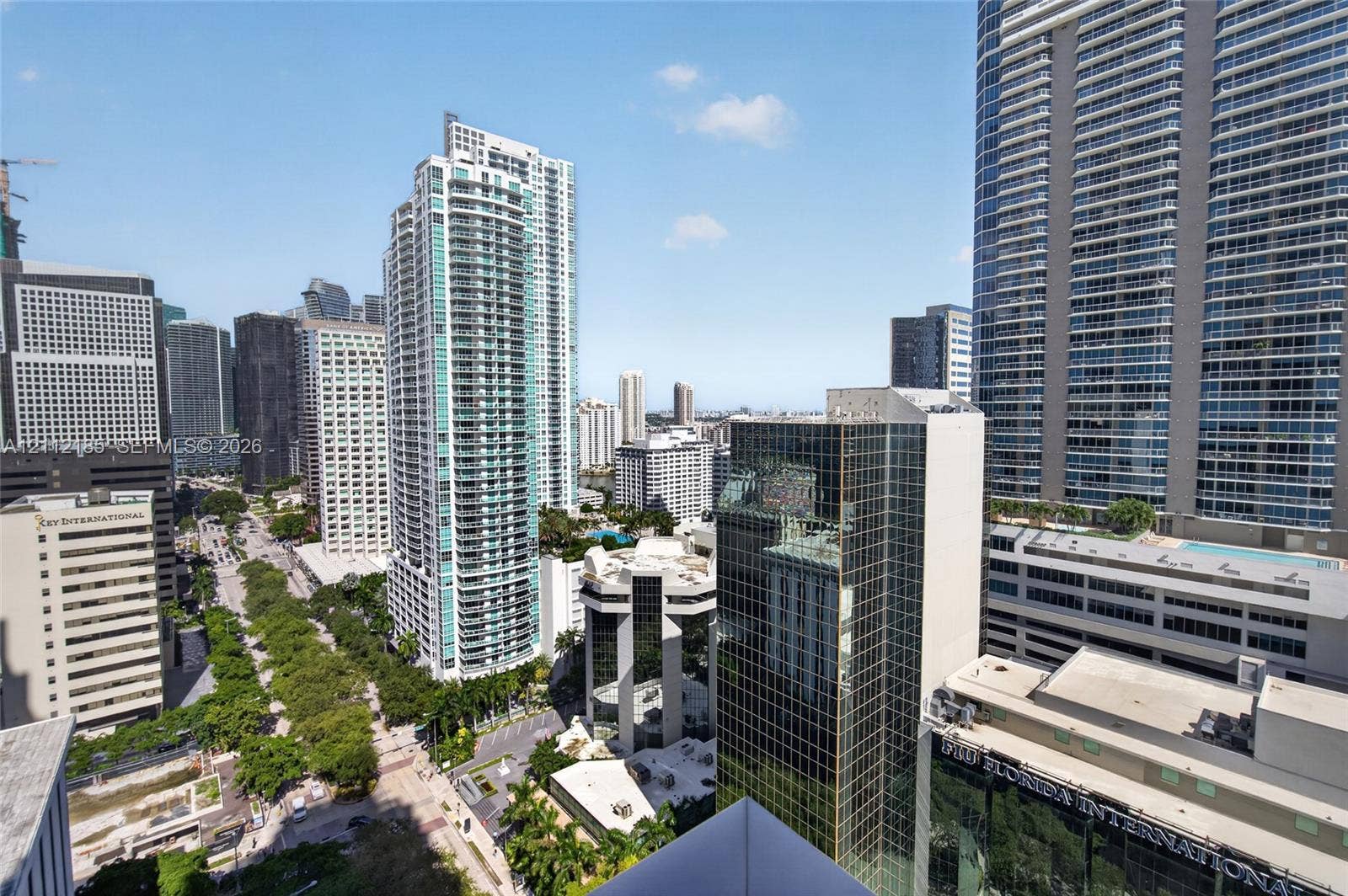 1060 Brickell Avenue, #2401, Miami, FL 33131 Urban skyline panorama featuring multi-story glass-facade skyscrapers, high-density metropolitan infrastructure, and established tree-lined boulevards