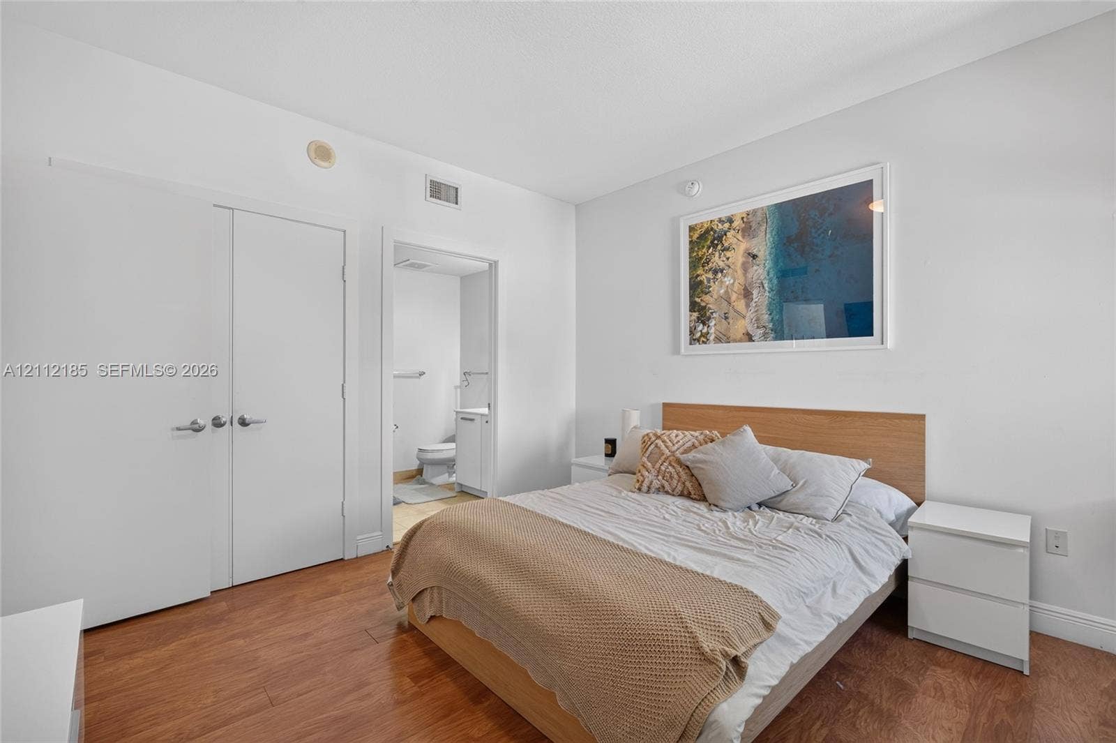 1060 Brickell Avenue, #2401, Miami, FL 33131 Wood-finish flooring and double-door closet with brushed nickel hardware