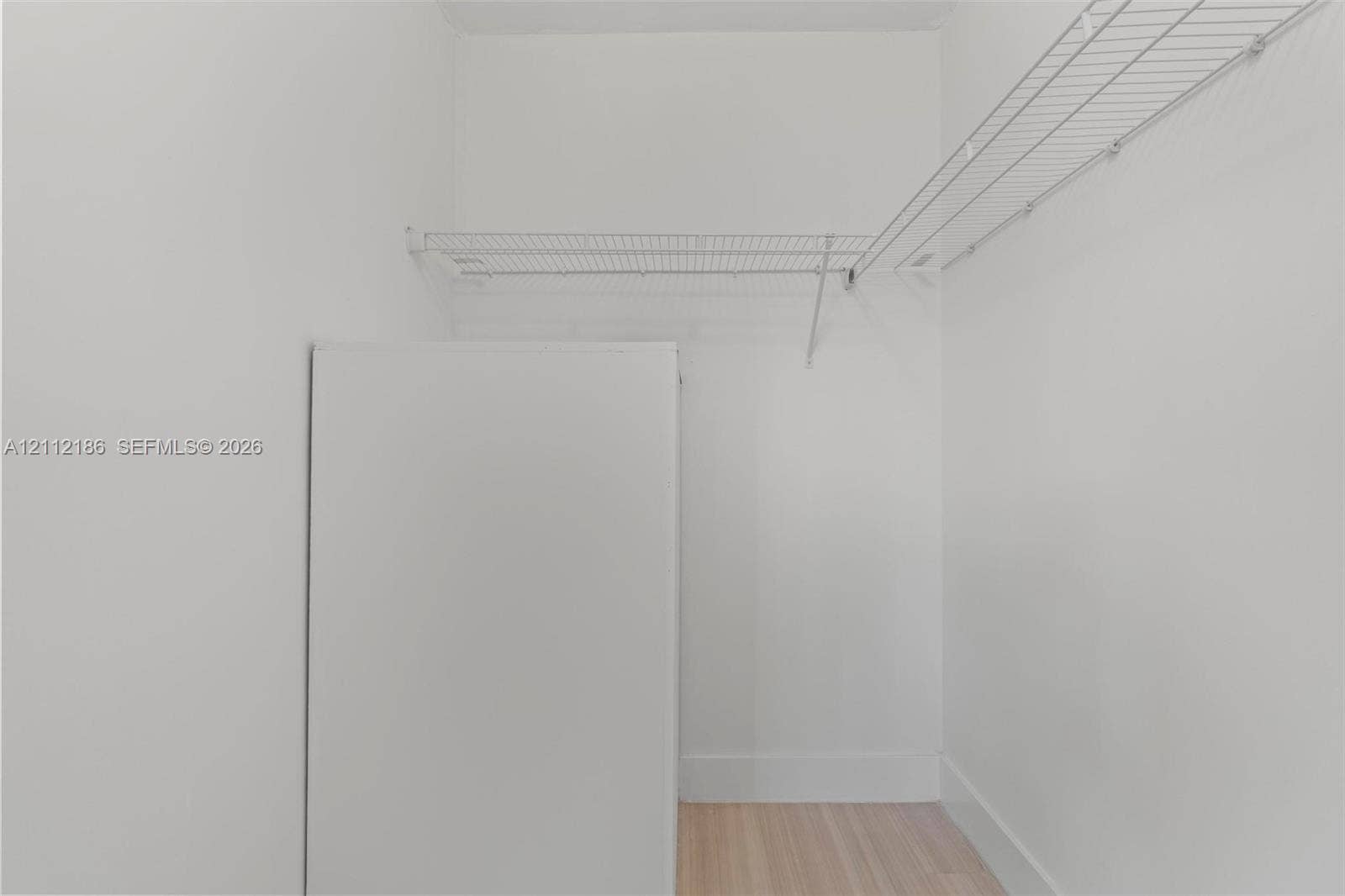 1300 SW 124th Terrace, #107P, Pembroke Pines, Pembroke Pines, FL 33027 Storage area featuring white walls, wood-finish flooring, and integrated white wire shelving