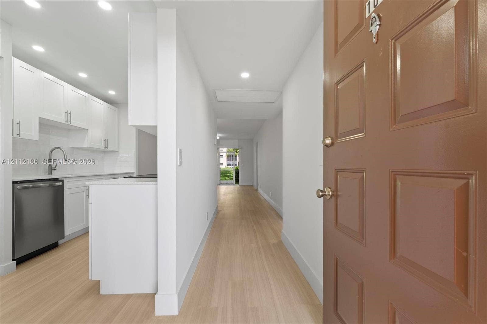 1300 SW 124th Terrace, #107P, Pembroke Pines, Pembroke Pines, FL 33027 Entryway featuring recessed lighting, wood-finish flooring, white cabinetry, a stainless steel dishwasher, and a gooseneck faucet