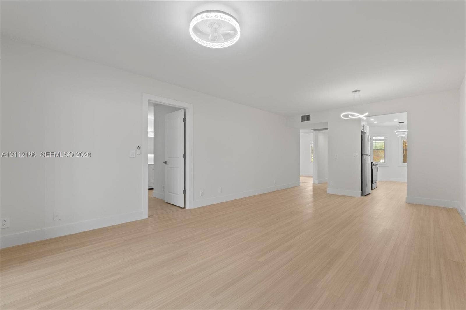 1300 SW 124th Terrace, #107P, Pembroke Pines, Pembroke Pines, FL 33027 Light-toned wood-finish flooring, recessed lighting, and contemporary circular LED ceiling fixtures