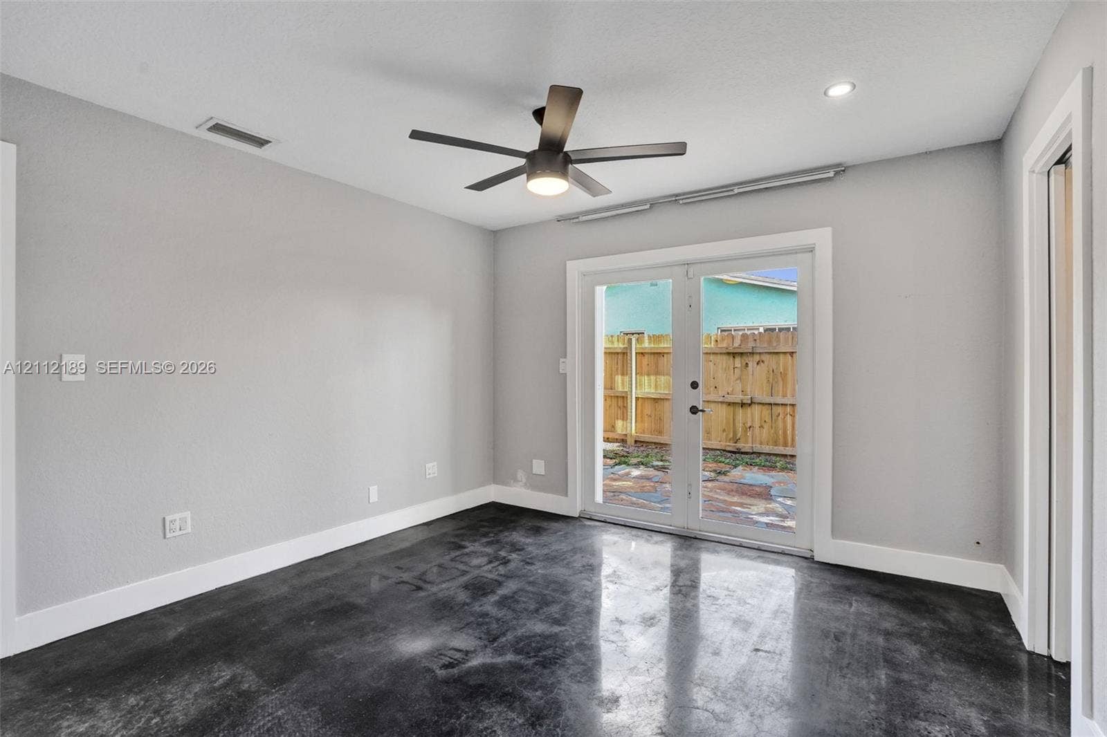 5161 SW 7th Court, #0, Margate, Margate, FL 33068 Neutral-toned interior featuring stained concrete flooring, recessed lighting, a modern ceiling fan, and glass French doors