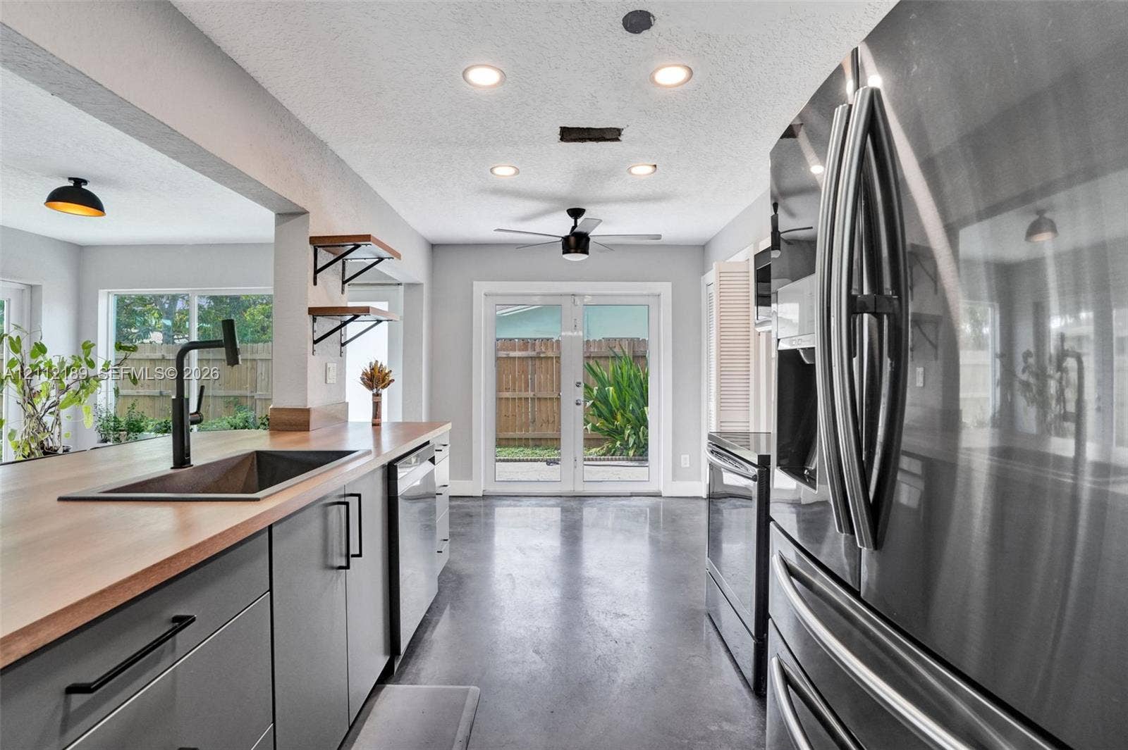 5161 SW 7th Court, #0, Margate, Margate, FL 33068 Kitchen featuring grey flat-panel cabinetry, wood-surface countertops, a matte black faucet with an undermount sink, stainless steel appliances, and polished concrete flooring