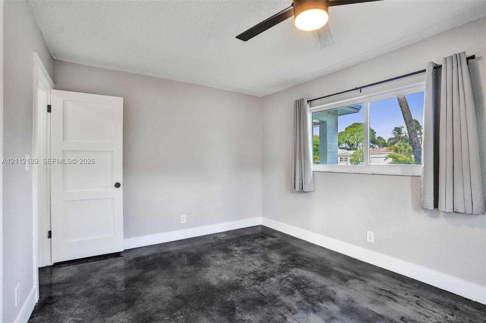 5161 SW 7th Court, #0, Margate, Margate, FL 33068 Polished concrete flooring, three-panel interior door, and ceiling fan with integrated lighting