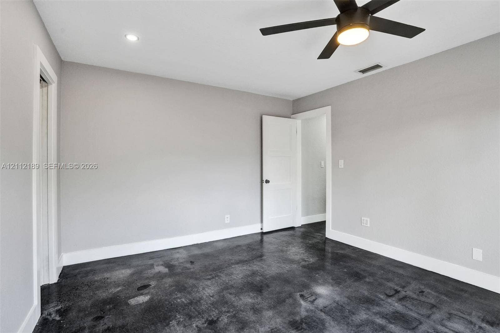 5161 SW 7th Court, #0, Margate, Margate, FL 33068 Polished concrete flooring, recessed lighting, matte black ceiling fan with integrated light, and crisp neutral wall paint