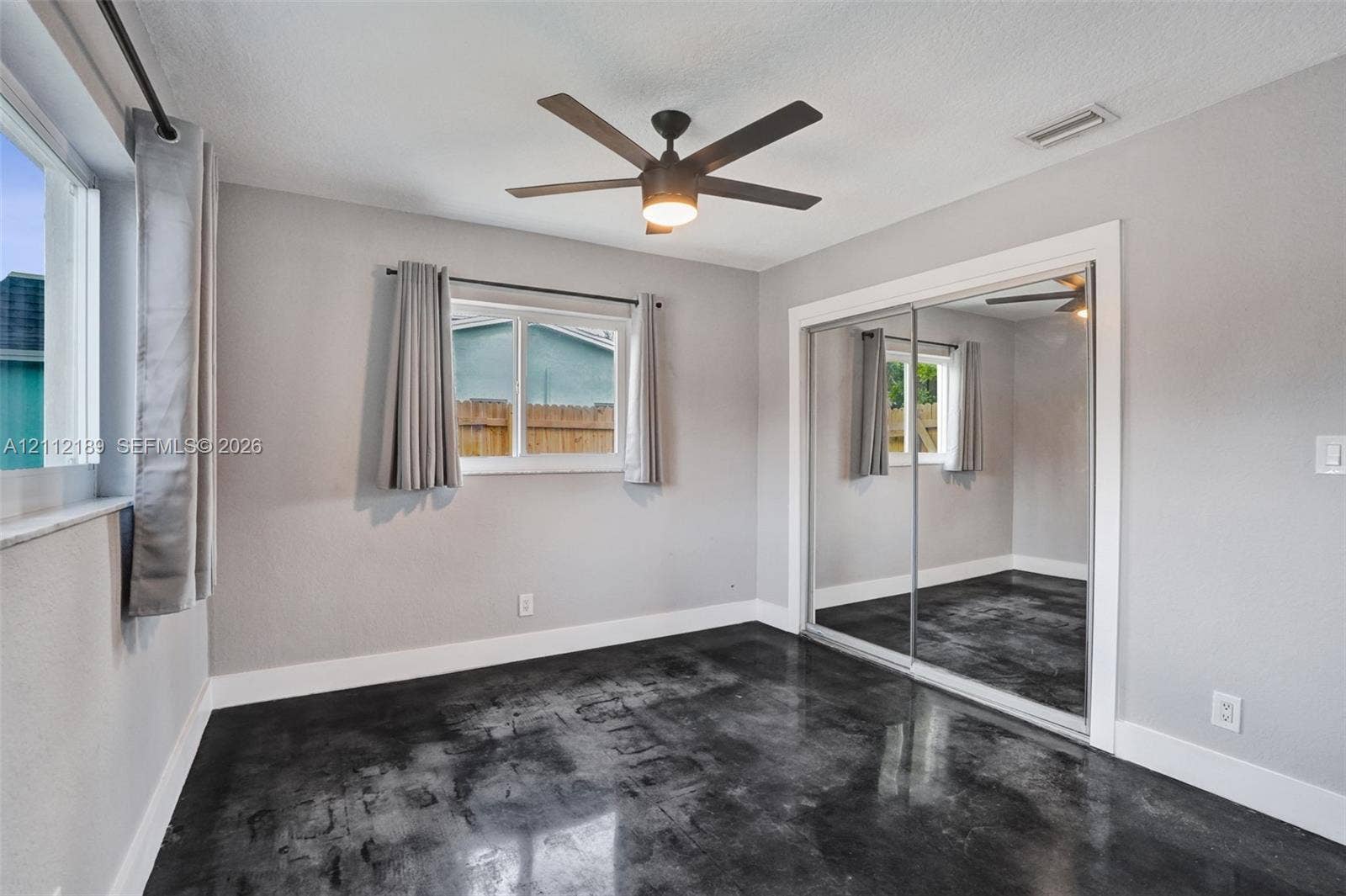 5161 SW 7th Court, #0, Margate, Margate, FL 33068 Polished concrete flooring, sliding mirrored closet doors, ceiling fan with integrated lighting, and multi-pane windows