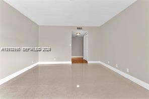440 Lakeview Drive, #103, Weston, Weston, FL 33326 Neutral interior space featuring polished tile flooring, light-toned walls, and recessed ceiling lighting