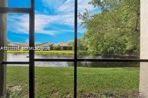 440 Lakeview Drive, #103, Weston, Weston, FL 33326 Screened enclosure featuring water frontage and mature landscaping