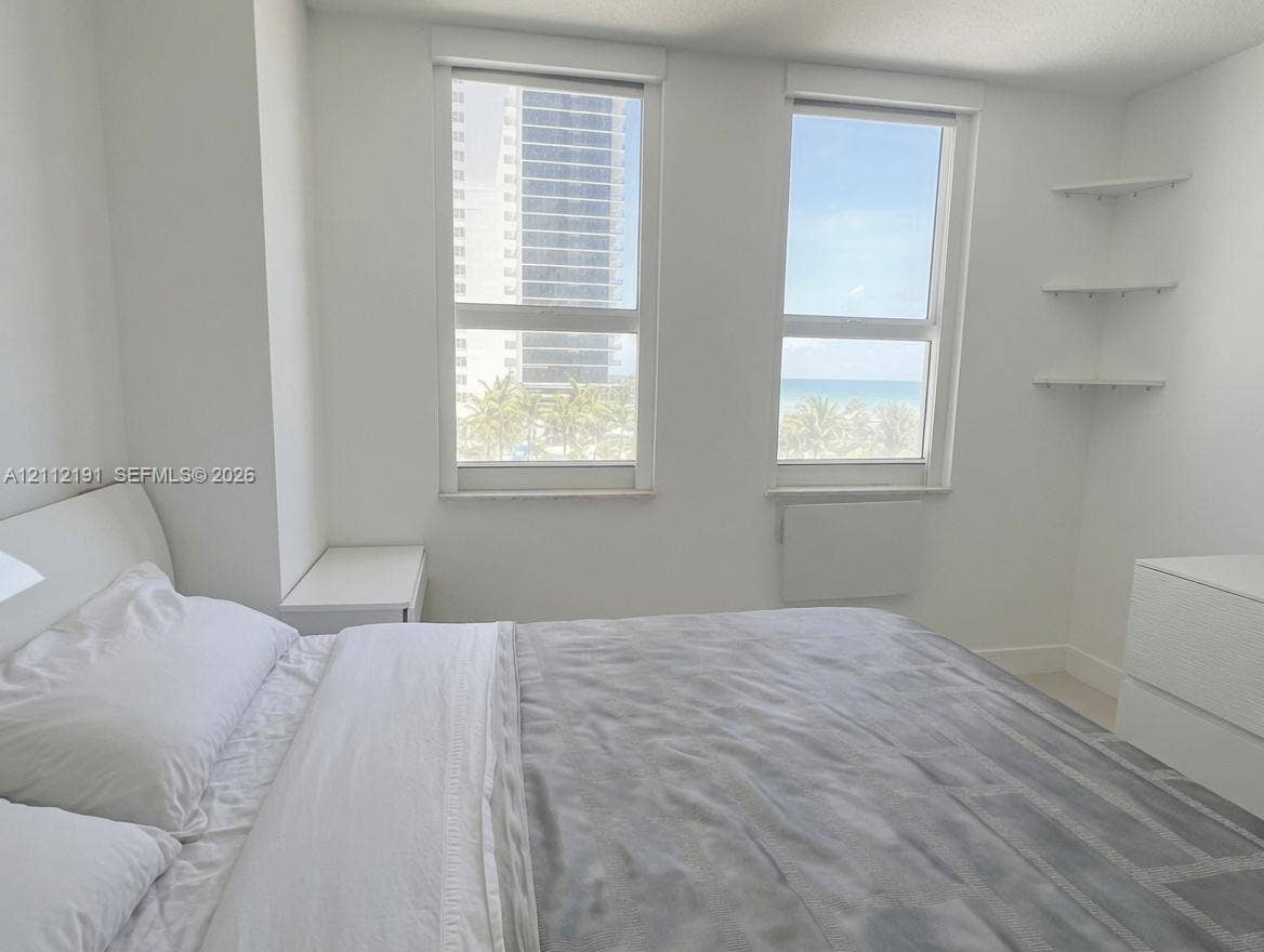 Dual vertical windows featuring built-in corner shelving and neutral wall finishes