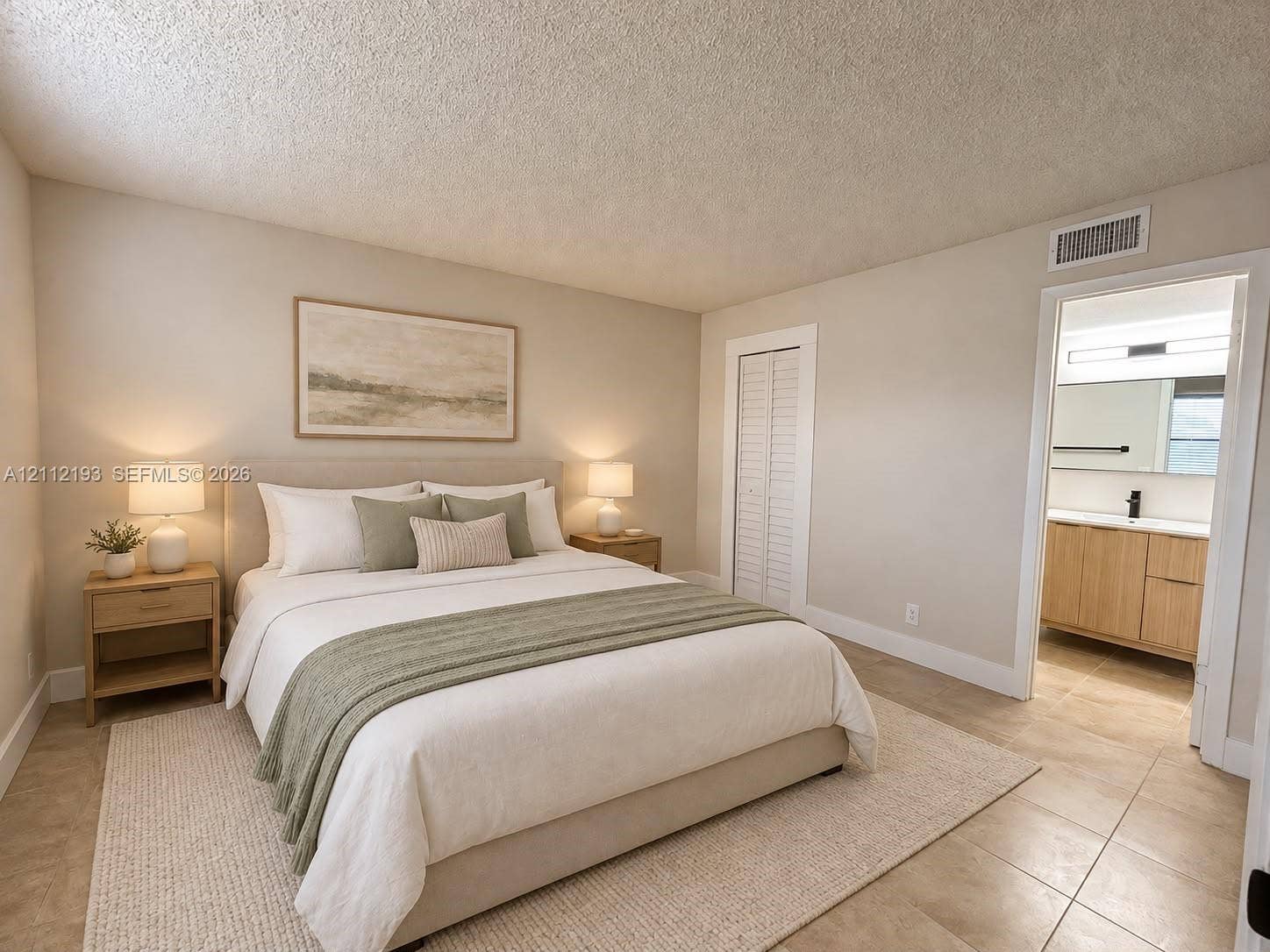 10013 Winding Lake Road, #106, Sunrise, Sunrise, FL 33351 Neutral-toned interior featuring tiled flooring, a textured ceiling, and louvered closet doors