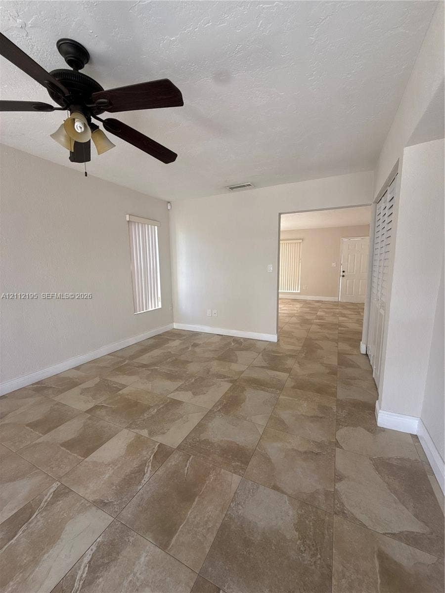 11745 SW 122nd Place, #11745, Miami, Miami, FL 33186 Large-format neutral tile flooring throughout with a multi-light ceiling fan and louvered-style closet doors