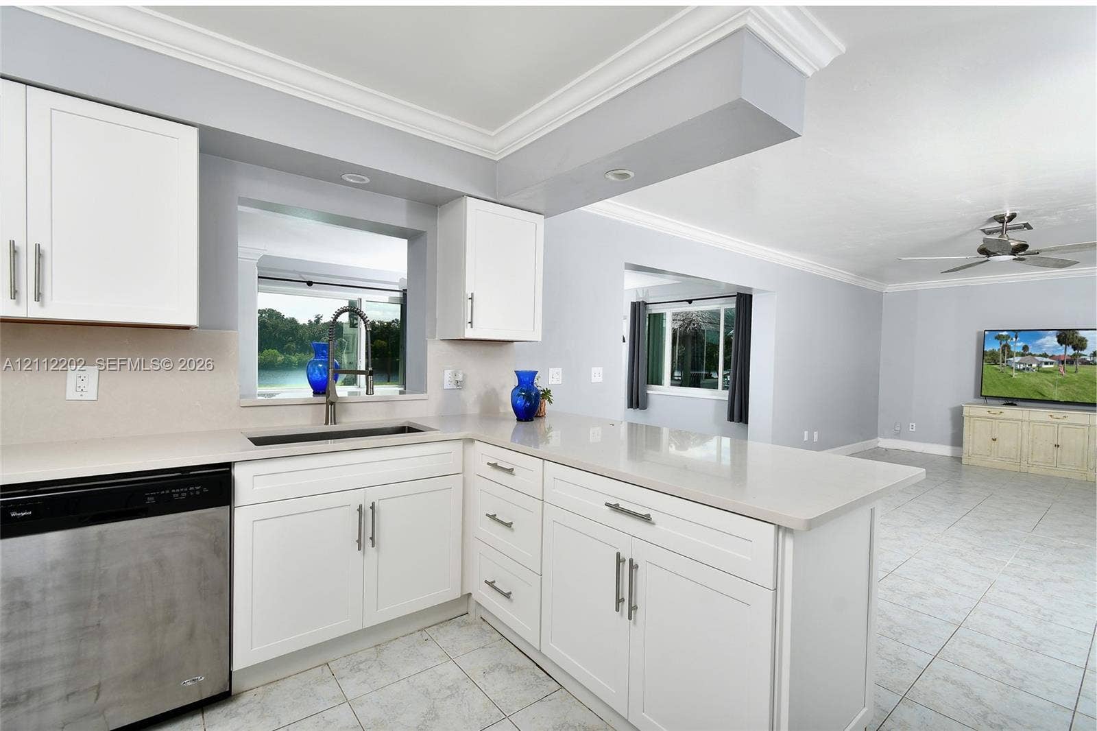 3233 Shell Lane, Labelle, FL 33935 Kitchen featuring white shaker-style cabinetry, quartz countertops, stainless steel undermount sink, and recessed lighting, finished with ceramic tile flooring