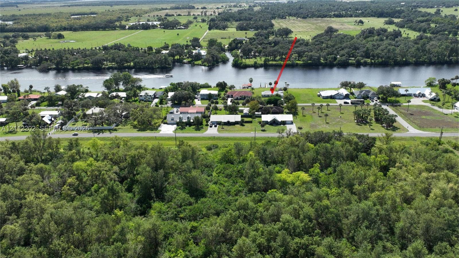 3233 Shell Lane, Labelle, FL 33935 Waterfront property featuring extensive acreage, mature trees, and direct river access