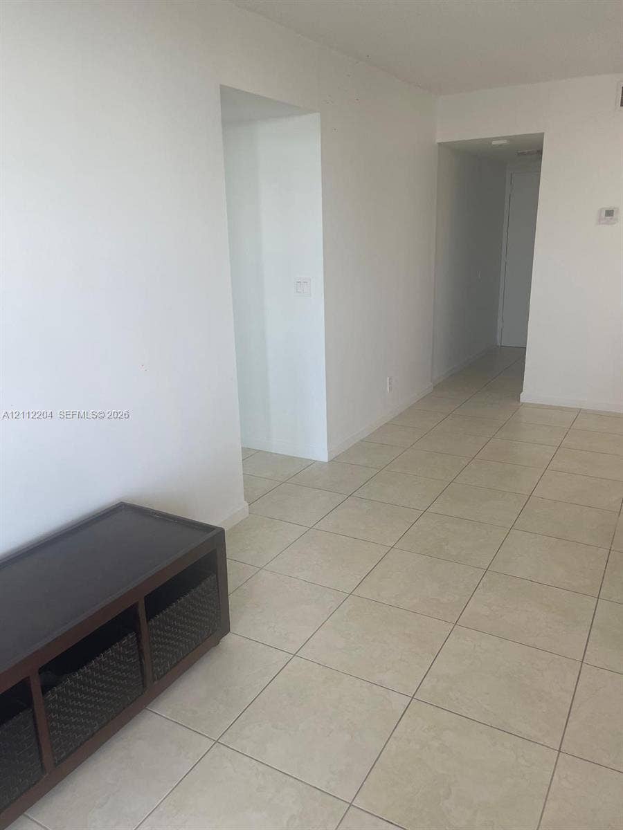 2020 NE 135th Street, #910, North Miami, North Miami, FL 33181 Neutral ceramic tile flooring and white wall finishes