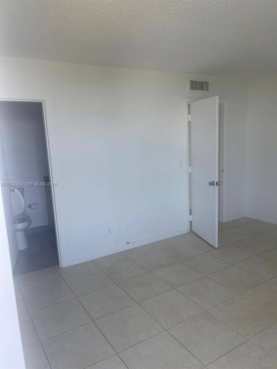 2020 NE 135th Street, #910, North Miami, North Miami, FL 33181 Neutral-toned tile flooring, solid-core interior doors, and clean-finished walls