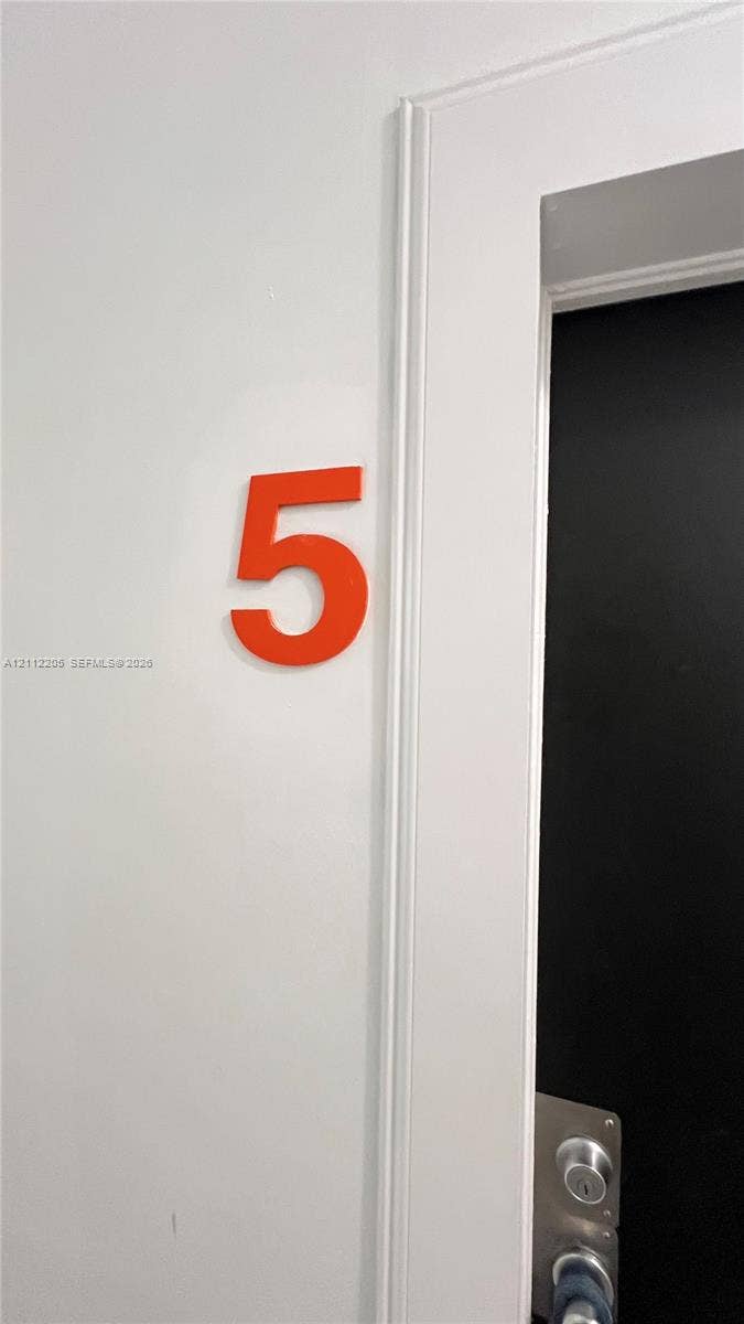 1115 Euclid Avenue, #5, Miami Beach, Miami Beach, FL 33139 Dimensional numeral identifier featuring a bold orange finish, mounted on a smooth white wall with traditional door casing and metal hardware
