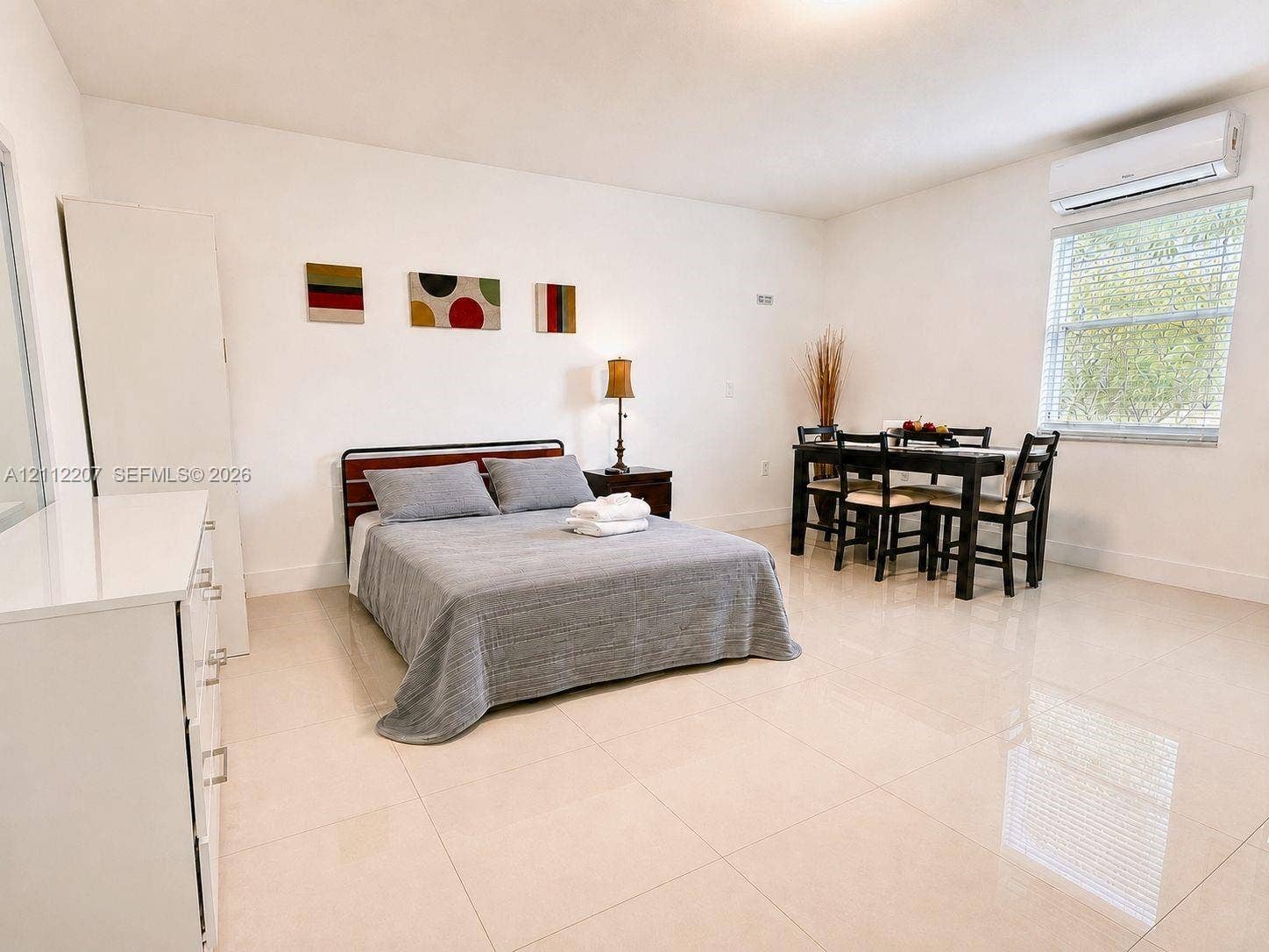 525 SW 67th Avenue, Miami, Miami, FL 33144 Room featuring neutral tile flooring, white wall finishes, and a wall-mounted ductless air conditioning unit