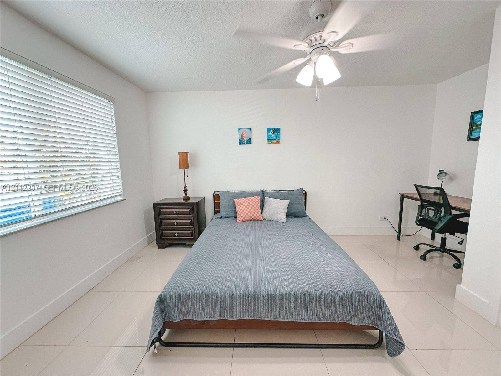 525 SW 67th Avenue, Miami, Miami, FL 33144 Neutral wall finishes, large-format tile flooring, white horizontal window blinds, and a white ceiling fan with integrated lighting