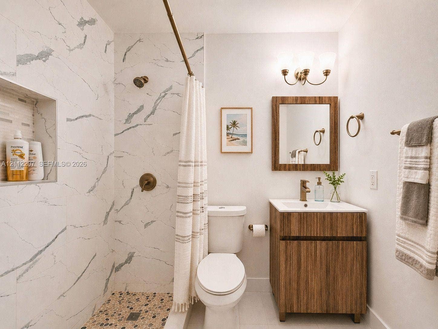 525 SW 67th Avenue, Miami, Miami, FL 33144 Bathroom featuring a walk-in shower with stone-look wall tile, a pebbled floor, and an integrated wall niche, complemented by a wood-finish vanity and a matching framed wall mirror