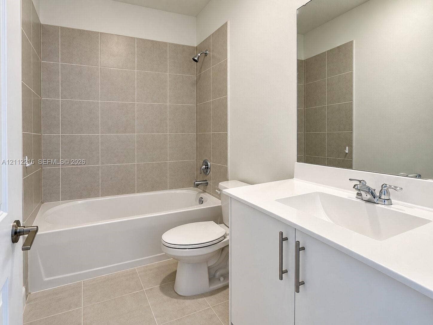 1161 SE 1 Street, #0, Florida City, Florida City, FL 33034 Bathroom featuring a vanity with a white countertop and integrated basin, a combination tub and shower with tile surround, and a large wall-mounted mirror
