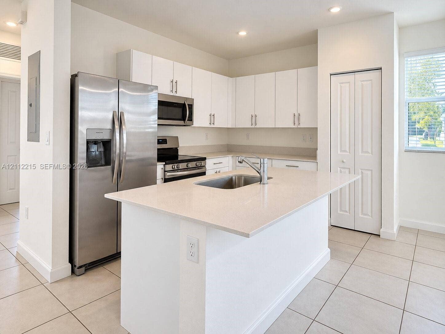 1161 SE 1 Street, #0, Florida City, Florida City, FL 33034 Kitchen featuring an island with a light-toned solid surface countertop, white shaker-style cabinetry, stainless steel appliances, and tile flooring