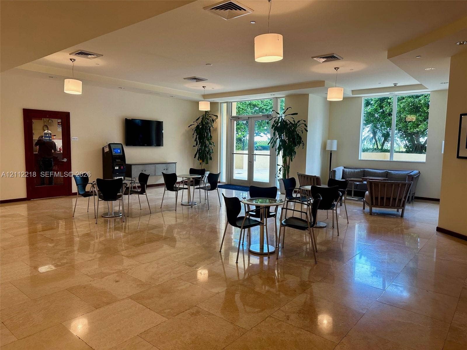 2475 Brickell Avenue, #1905, Miami, Miami, FL 33129 Open-concept lounge featuring polished stone flooring, recessed lighting, neutral wall tones, and glass-paneled double door entry
