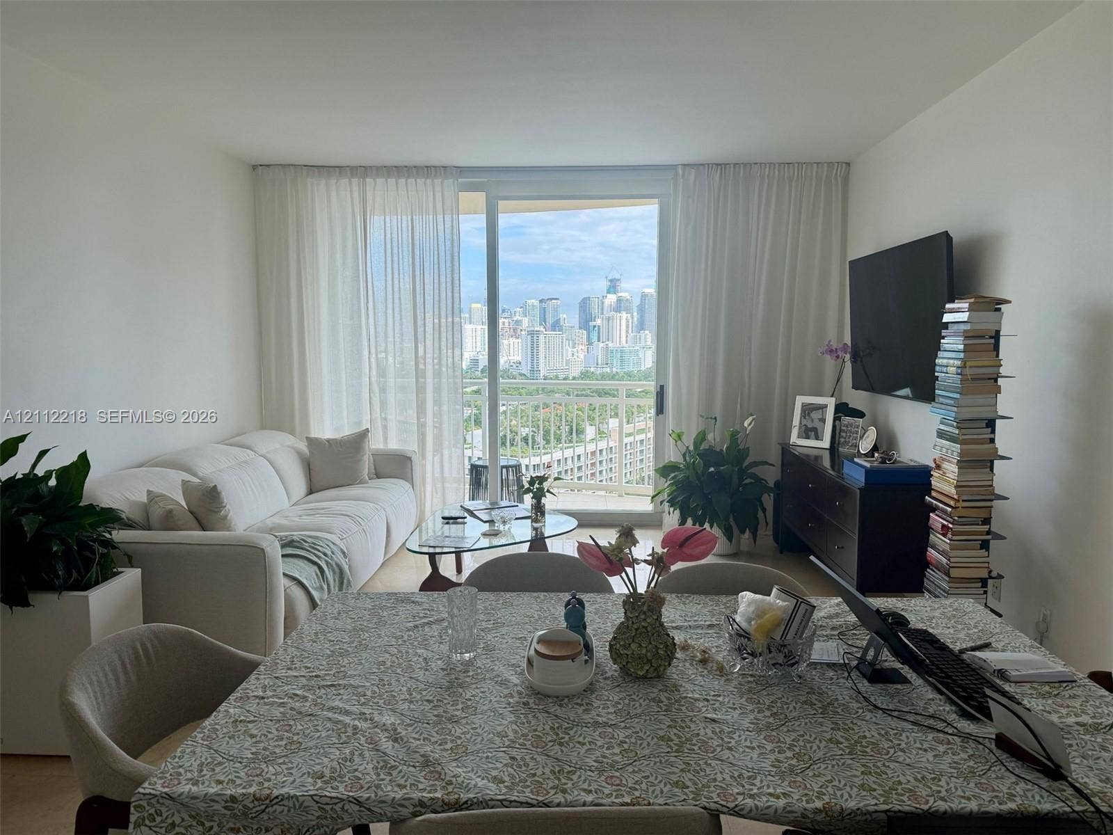 2475 Brickell Avenue, #1905, Miami, Miami, FL 33129 Floor-to-ceiling glass sliding door, metal-railed balcony, and urban skyline backdrop