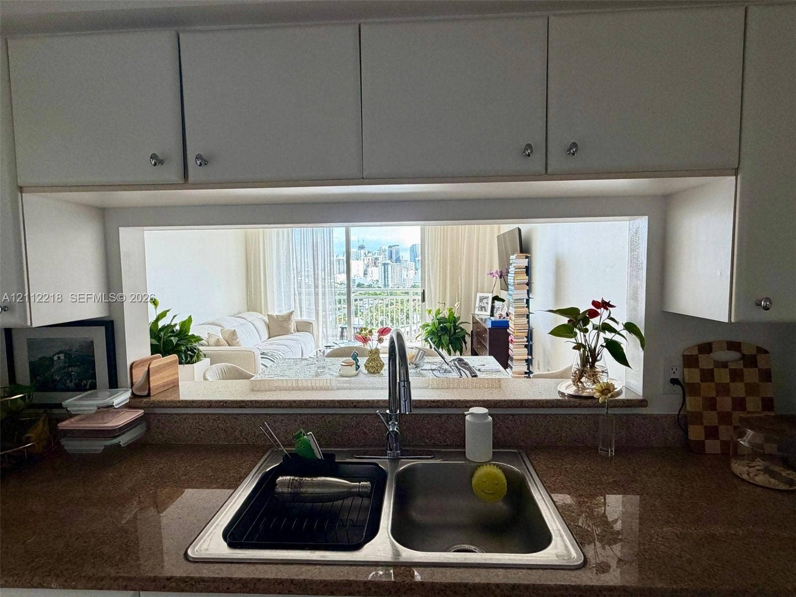 2475 Brickell Avenue, #1905, Miami, Miami, FL 33129 Kitchen featuring white upper cabinetry, stone-finish countertops, and an integrated stainless steel double-basin sink with a gooseneck faucet