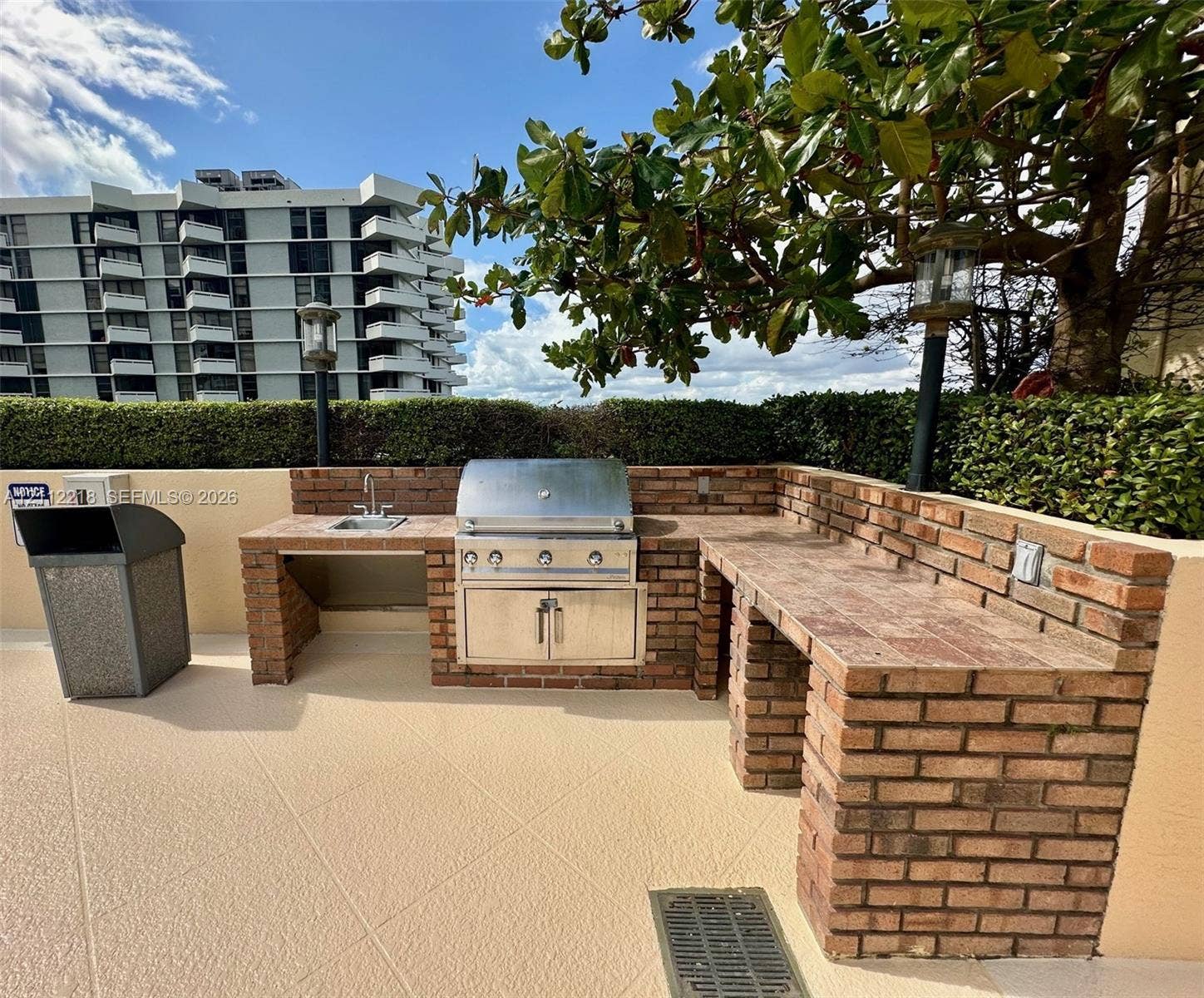 2475 Brickell Avenue, #1905, Miami, Miami, FL 33129 Outdoor grilling station featuring a masonry brick structure, stainless steel built-in grill, integrated prep counters, and a drop-in sink