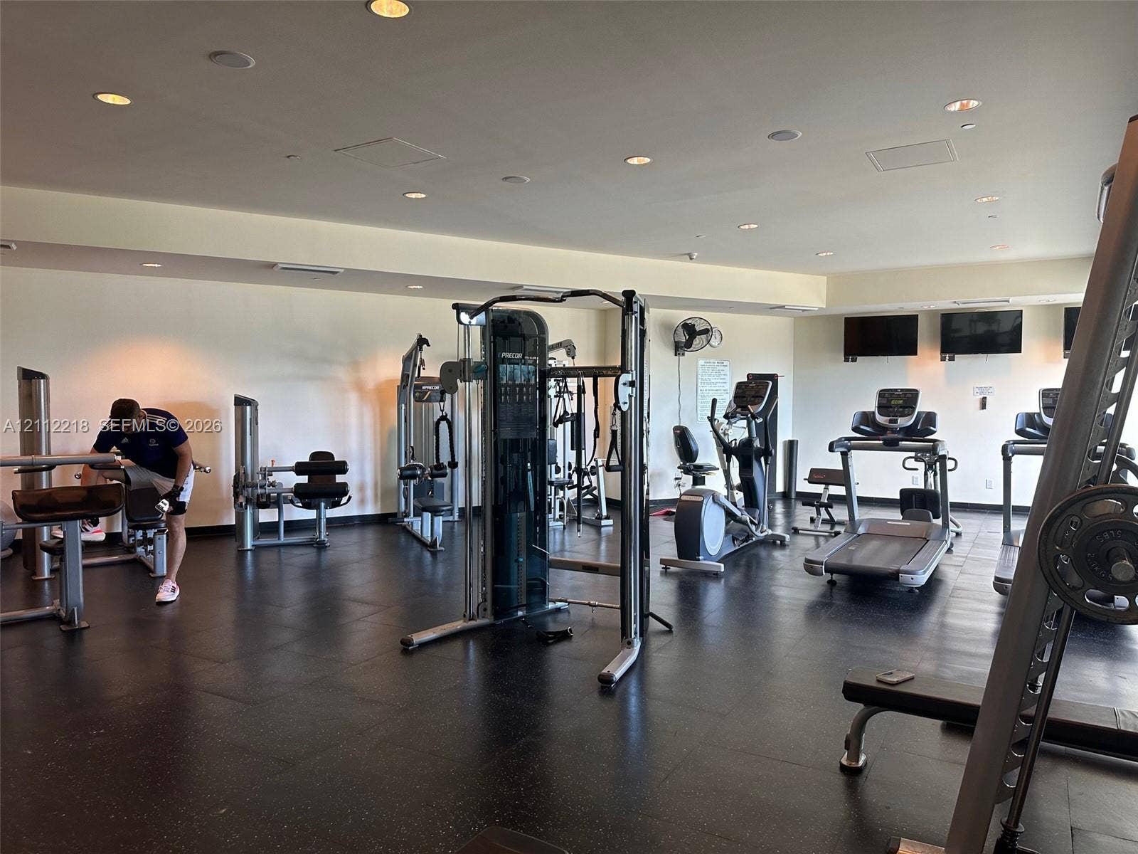 2475 Brickell Avenue, #1905, Miami, Miami, FL 33129 Fitness center featuring recessed lighting, dark composite flooring, and wall-mounted television screens