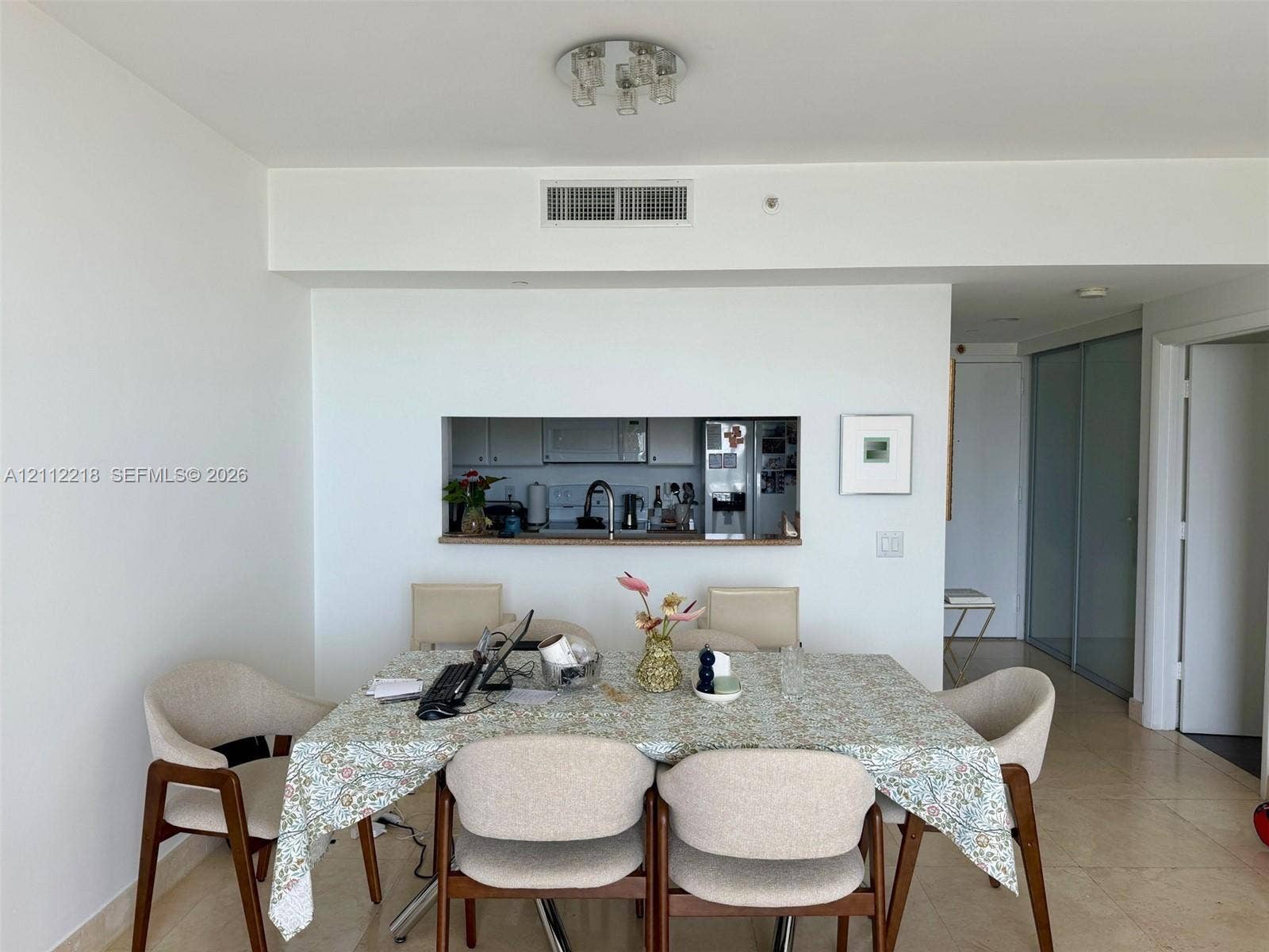 2475 Brickell Avenue, #1905, Miami, Miami, FL 33129 Pass-through window featuring a stone countertop, neutral tile flooring, and integrated ceiling-mounted lighting
