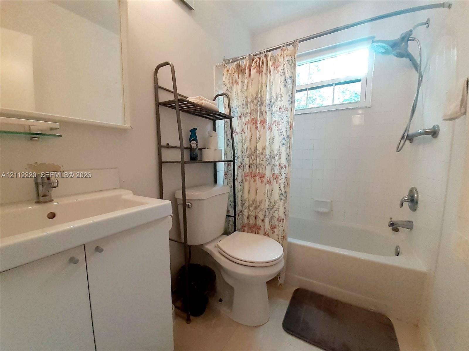508 W Westree Lane, #508, Plantation, Plantation, FL 33324 Bathroom featuring a vanity with an integrated sink, polished chrome faucet, white tiled shower surround, and a single-handle shower system