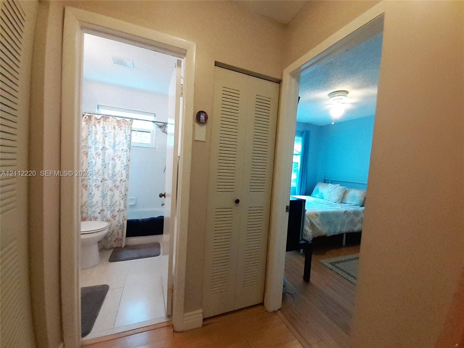 508 W Westree Lane, #508, Plantation, Plantation, FL 33324 Neutral interior featuring wood-finish flooring, white louvered bi-fold doors, and a ceiling-mounted light fixture