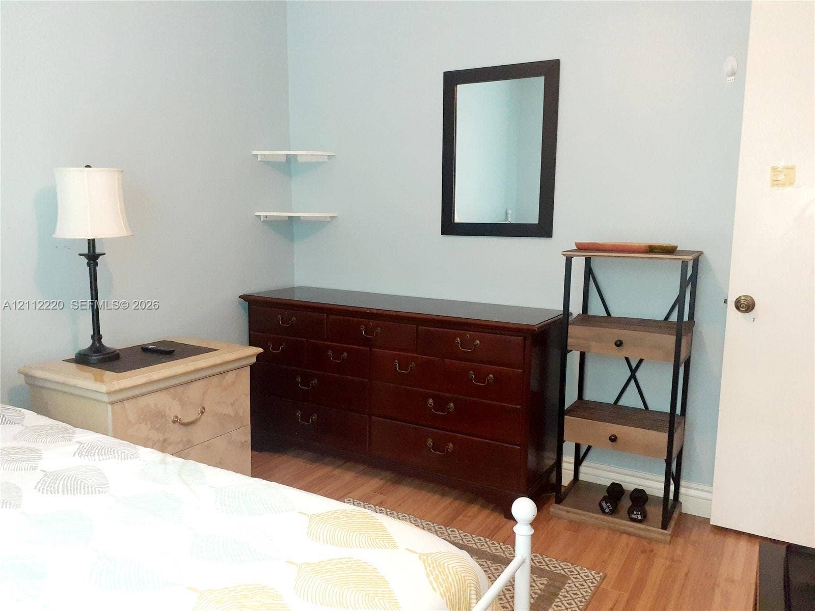 508 W Westree Lane, #508, Plantation, Plantation, FL 33324 Wood-finish flooring, wall-mounted floating shelving, and a wall-mounted rectangular mirror with a black frame