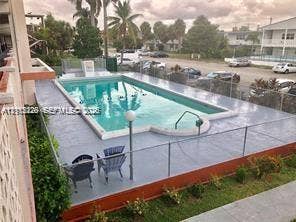 1450 NE 170th Street, #210, North Miami Beach, North Miami Beach, FL 33162 In-ground swimming pool featuring a concrete deck and metal perimeter fencing
