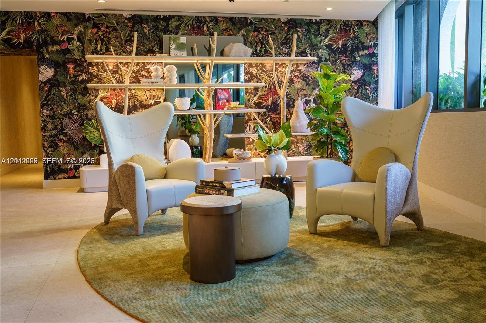 725 NE 24th Street, #706, Miami, Miami, FL 33137 Botanical-print accent wall, built-in structural display shelving, large-format tile flooring, and floor-to-ceiling windows