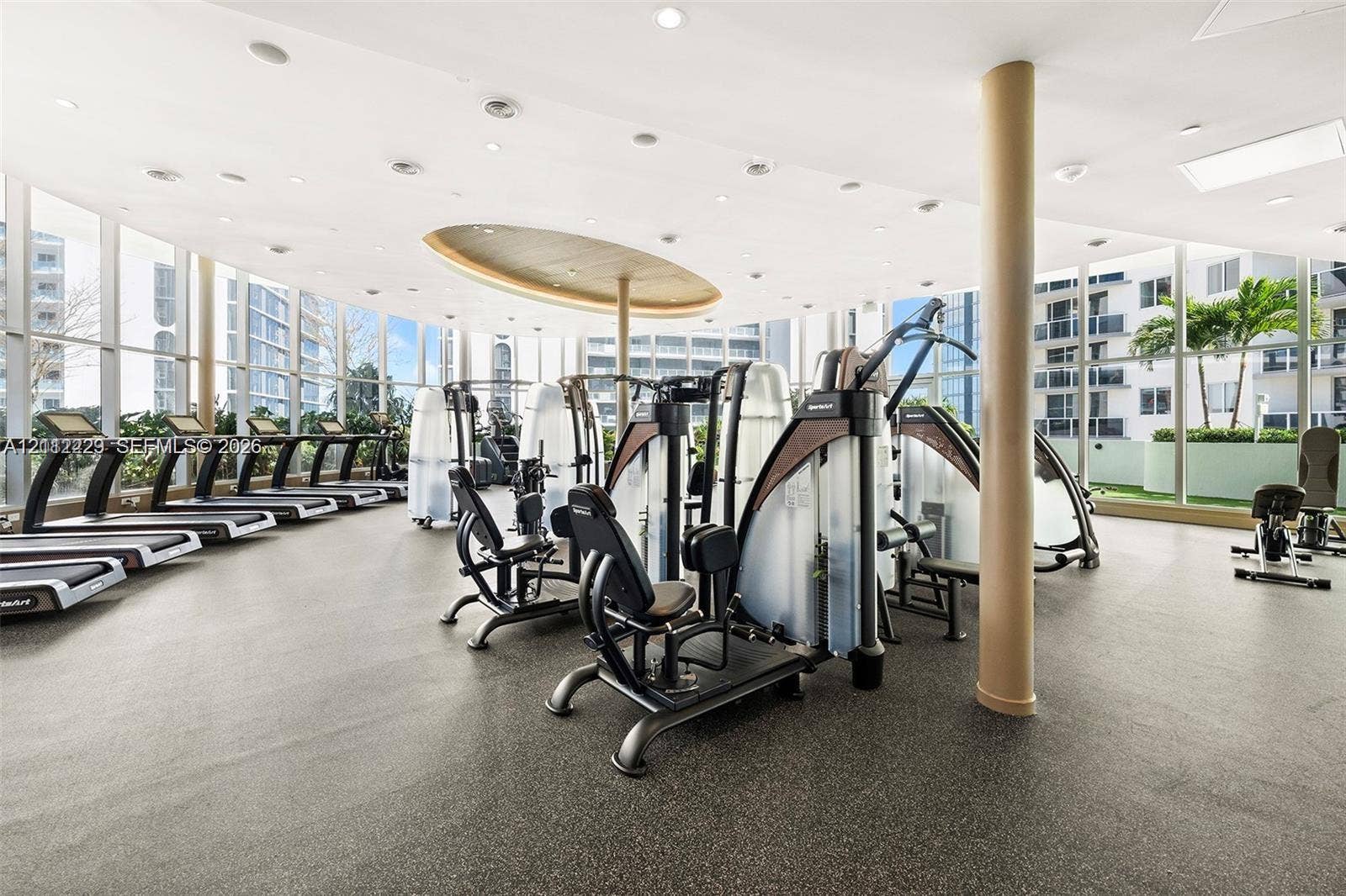 725 NE 24th Street, #706, Miami, Miami, FL 33137 Fitness center featuring floor-to-ceiling windows, recessed lighting, architectural ceiling detail, and rubberized flooring