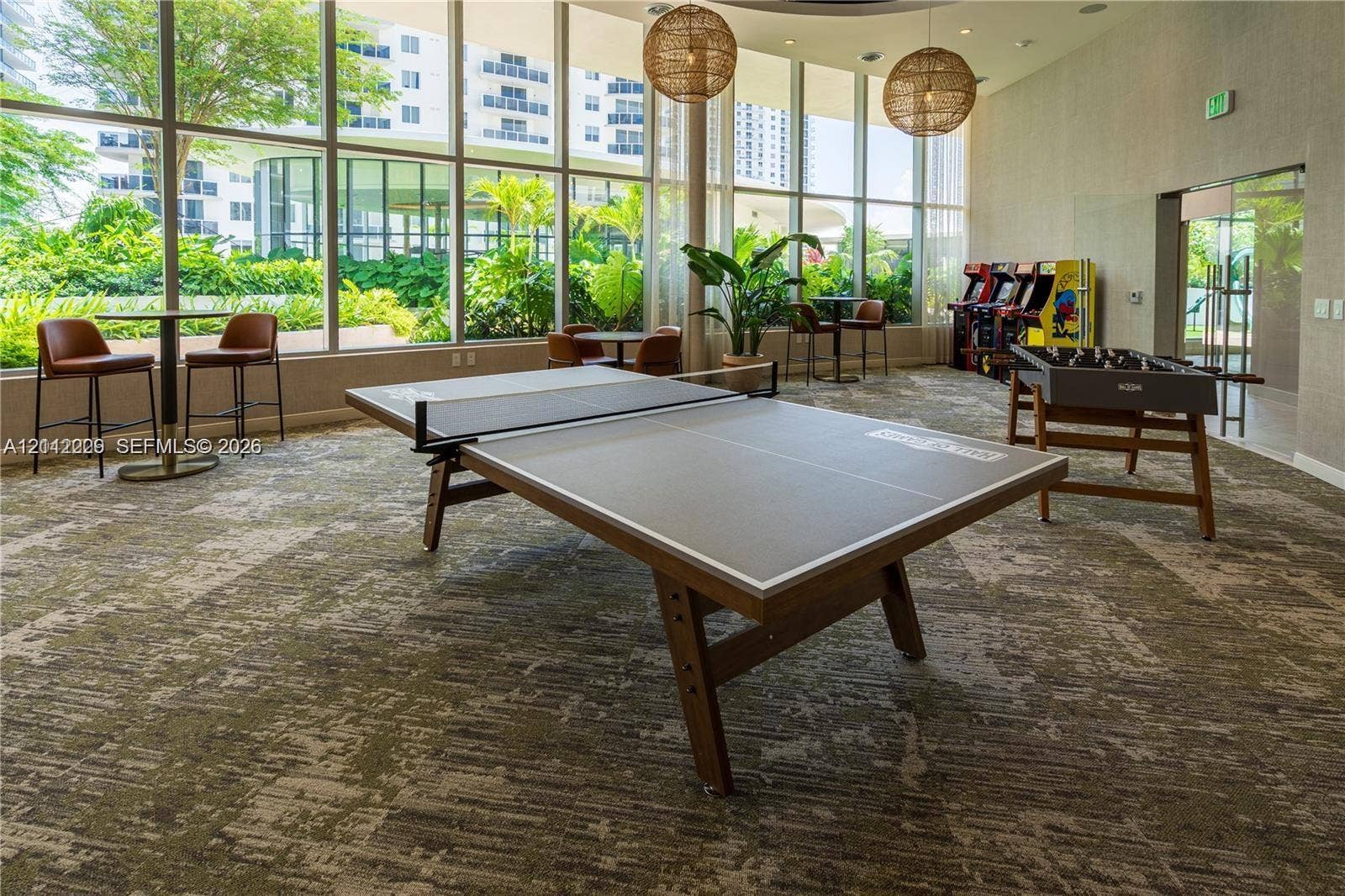 725 NE 24th Street, #706, Miami, Miami, FL 33137 Recreational space featuring floor-to-ceiling windows, patterned carpeting, and spherical pendant lighting
