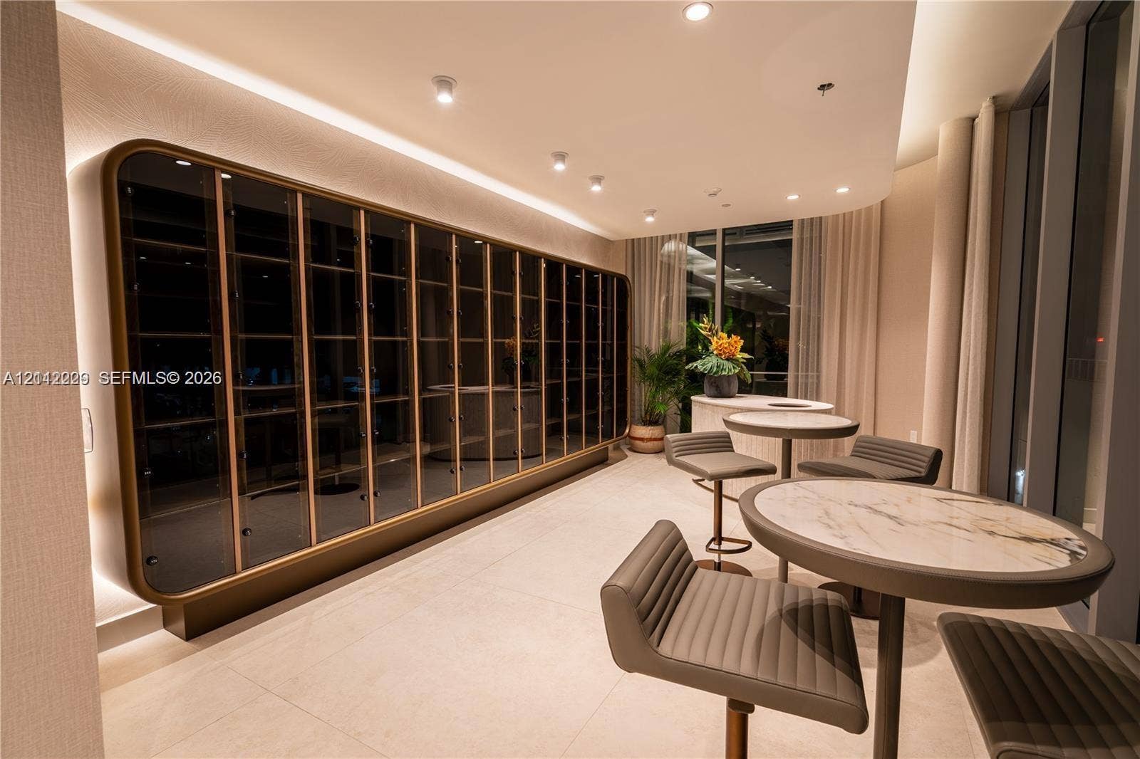 725 NE 24th Street, #706, Miami, Miami, FL 33137 Custom floor-to-ceiling built-in display cabinetry with metallic trim, recessed perimeter lighting, porcelain tile flooring, and integrated ceiling spotlights